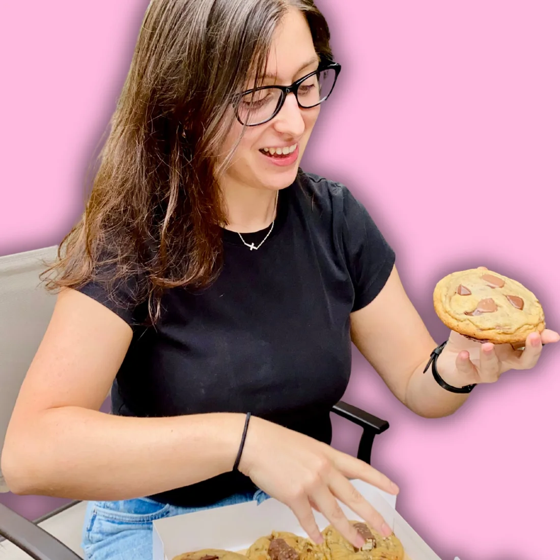 Nefeli filling a box of cookies