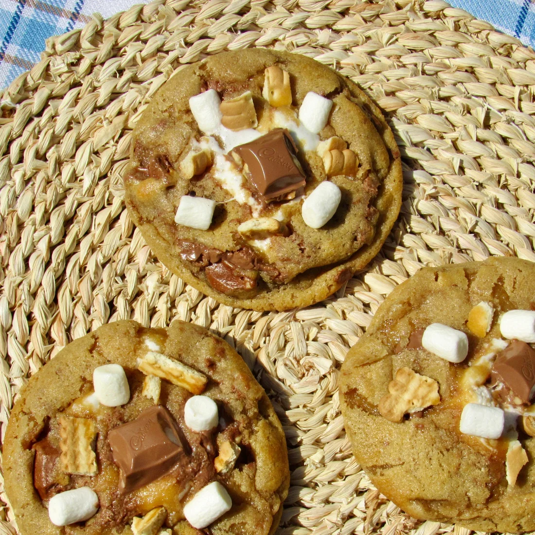 Fresh-baked s'mores cookies on a woven placemat